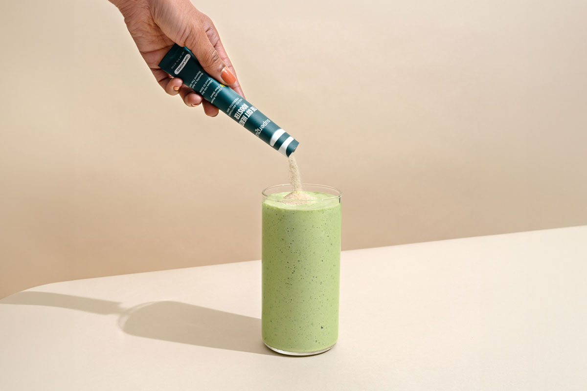 Supergut Gut Booster being poured into a drink