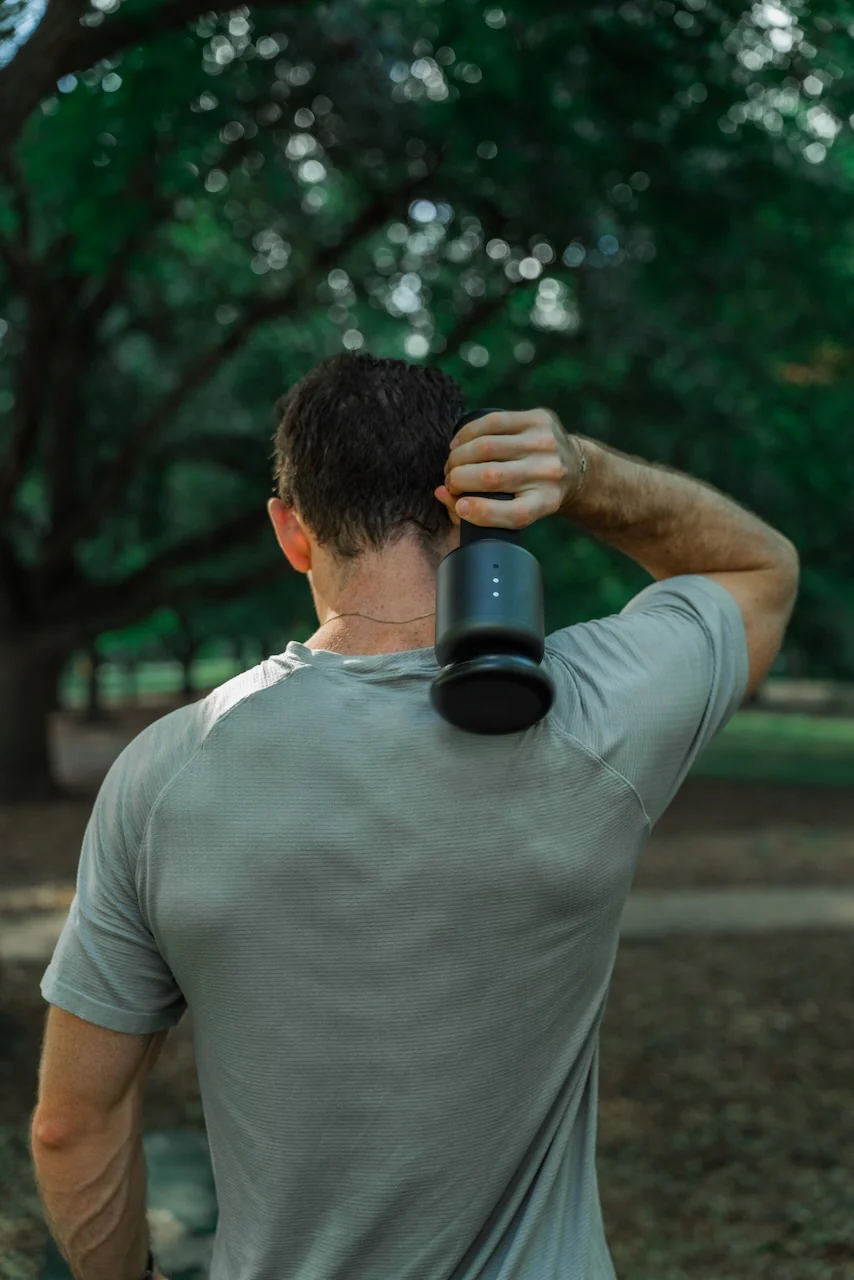 back view of a man using the rally orbital massager on his back